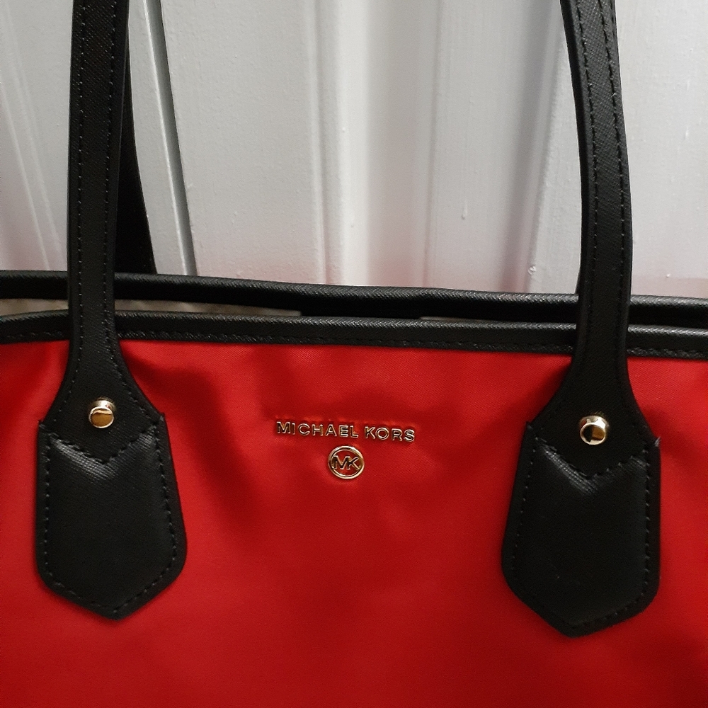 Red and black Michael Kors tote bag
